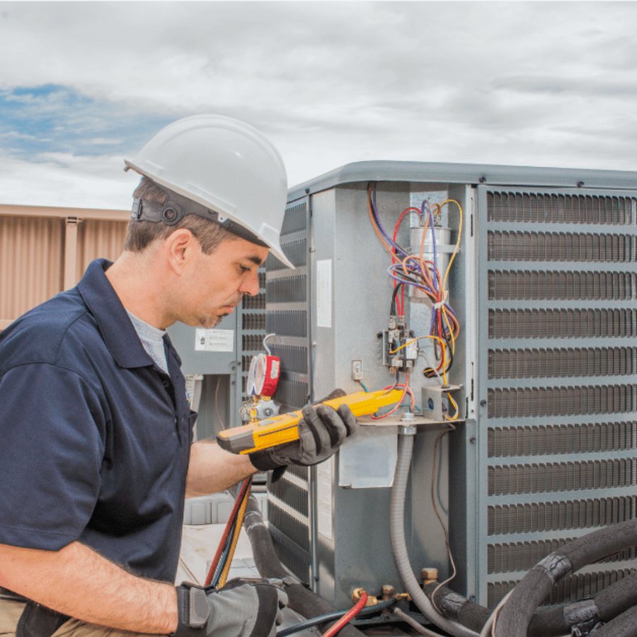 Simcoe Heating & Cooling HVAC technician servicing a system